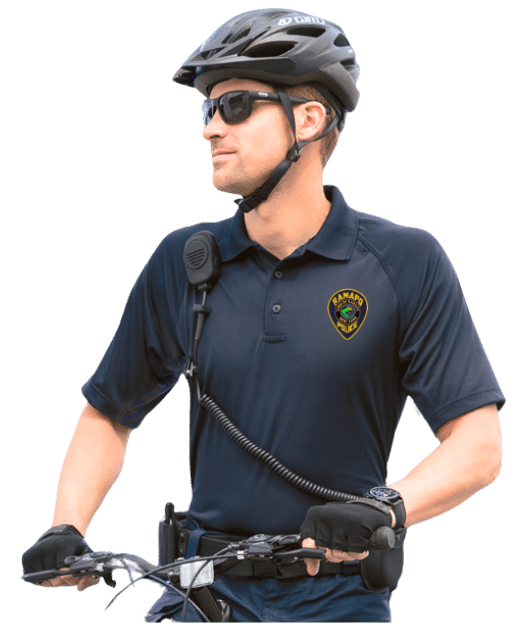 Police officer on bike patrol wearing a custom embroidered navy blue performance polo shirt by Promofect.