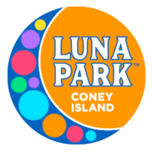 Luna Park entrance with rides, lights, and blue sky at Coney Island.