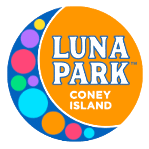 Luna Park entrance with rides, lights, and blue sky at Coney Island.