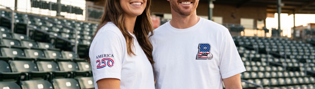 Custom baseball T-shirts worn at a baseball stadium.